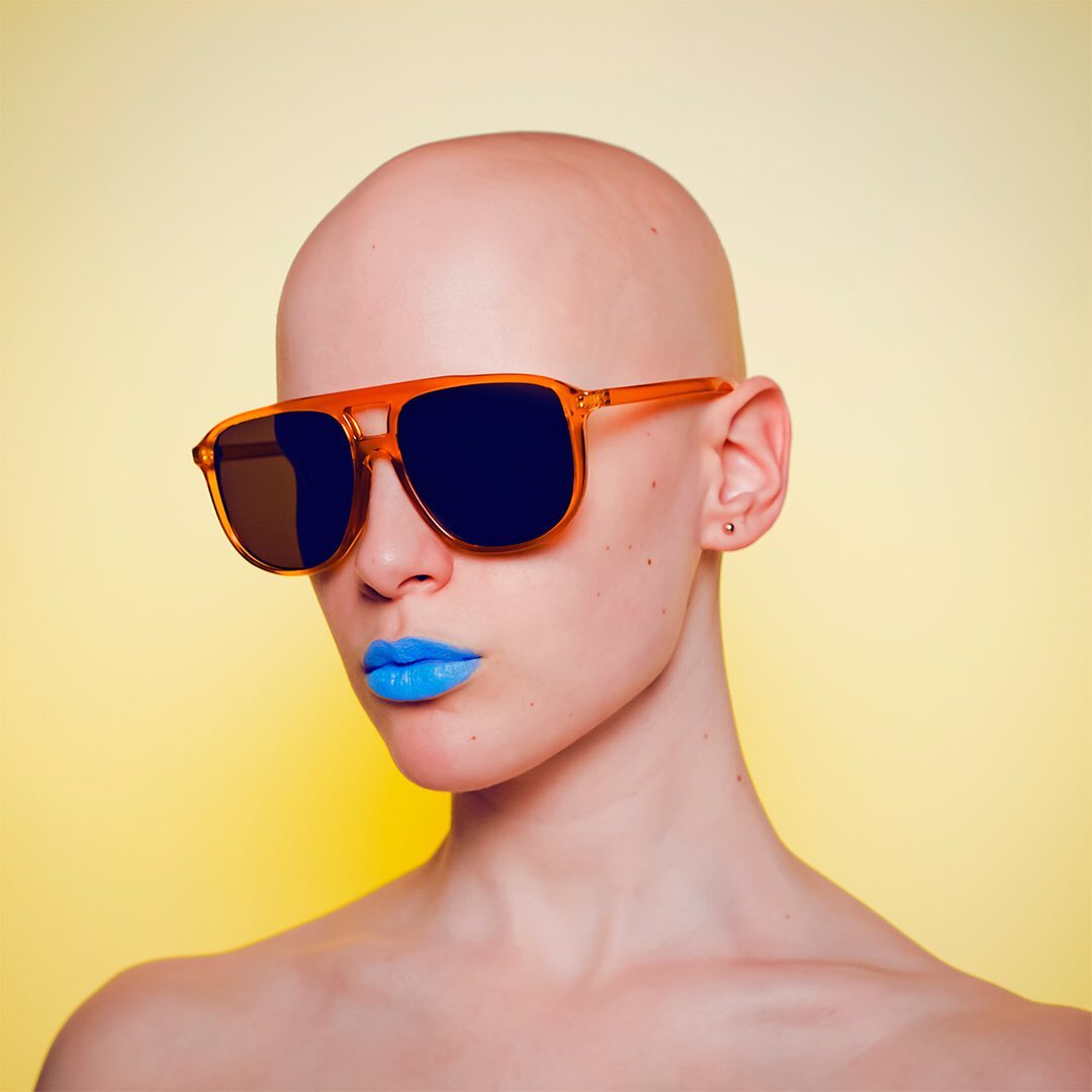 Actor and singer Joelle wearing sunglasses and blue lipstick.